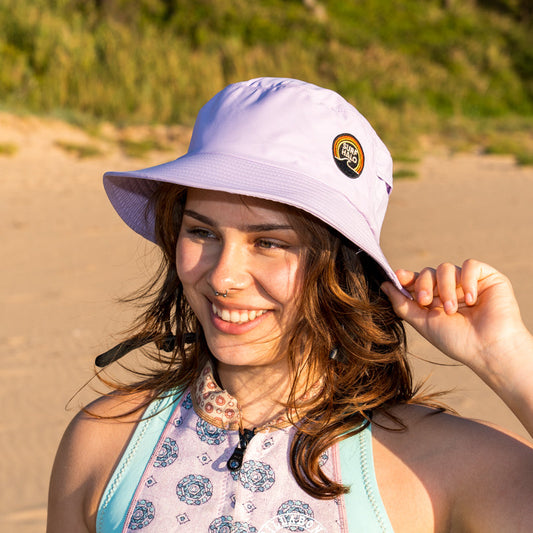 women wearing a surf hat wide brim in the sand surfer