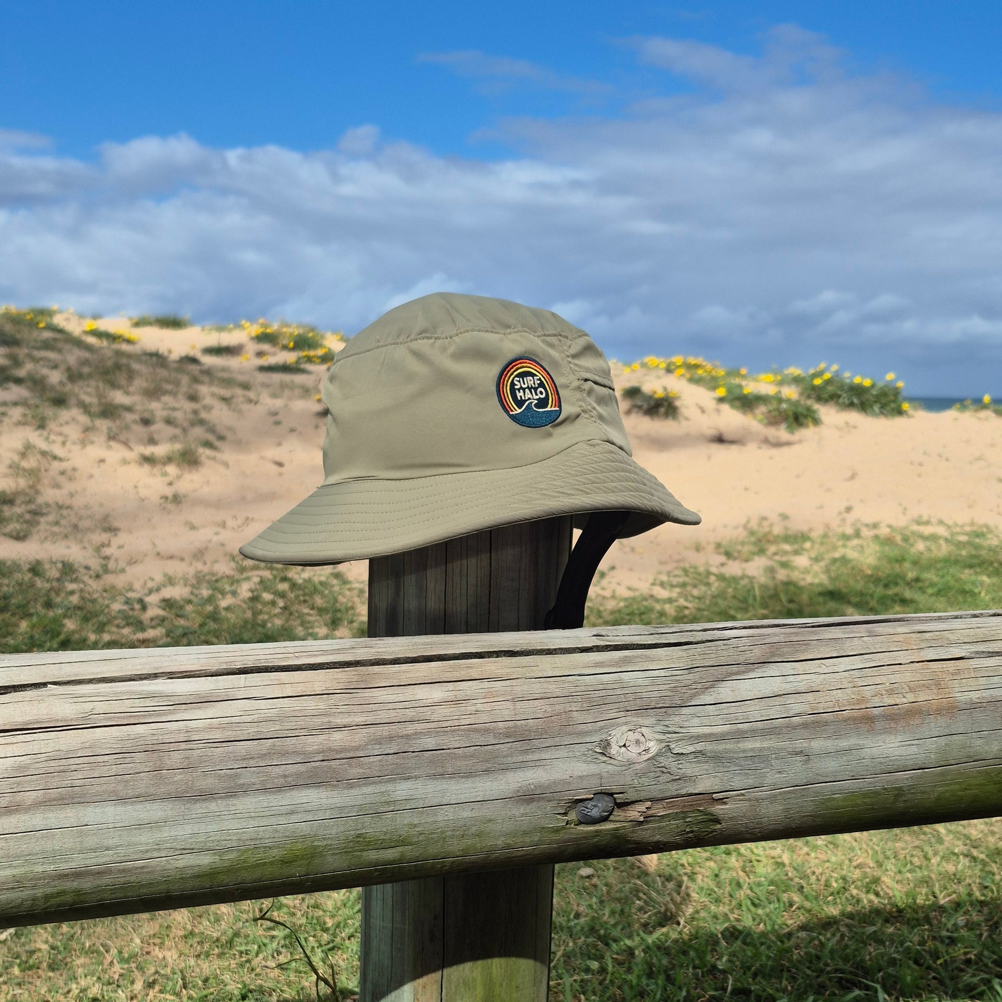 Green bucket surf hat helmet on the beach