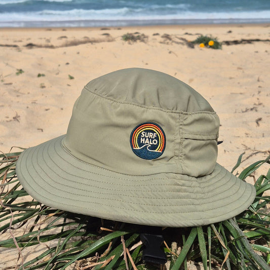Green Surf hat helmet on a beach