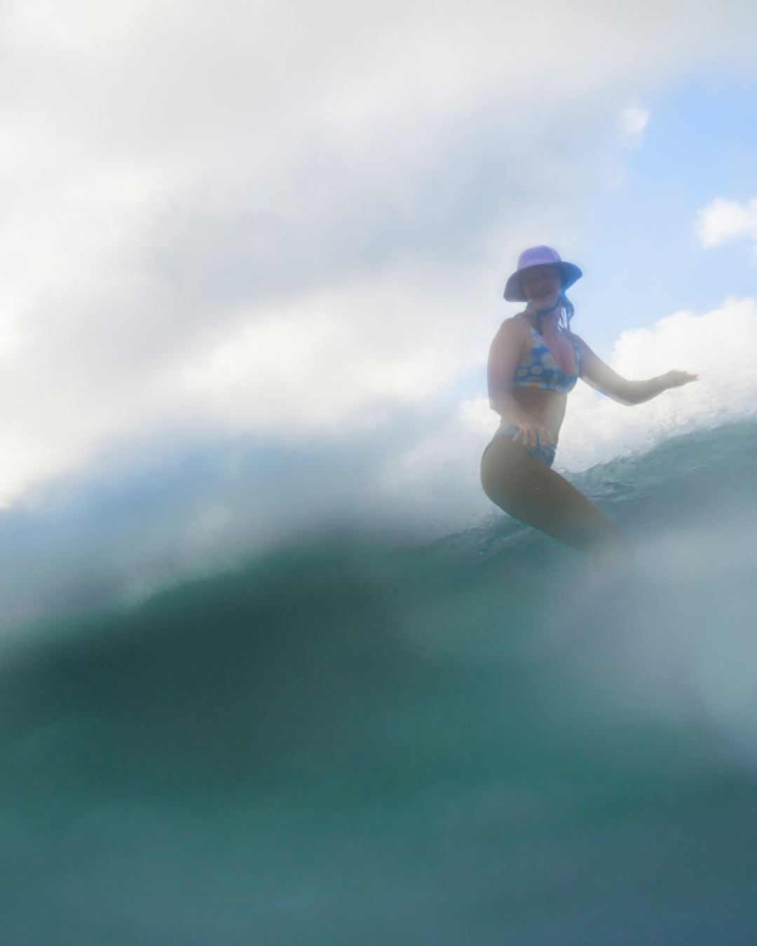 Women surfing wearing pink surf helmet surf hat 